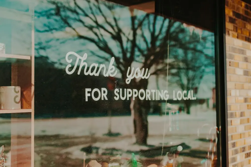 Thank you for supporting local sign on window, illustrating local economy